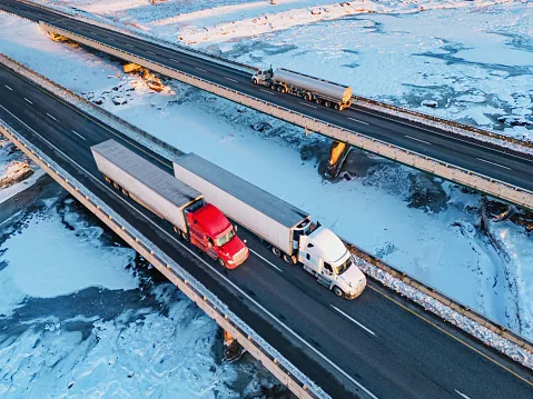 Semi trucks crossing frozen river